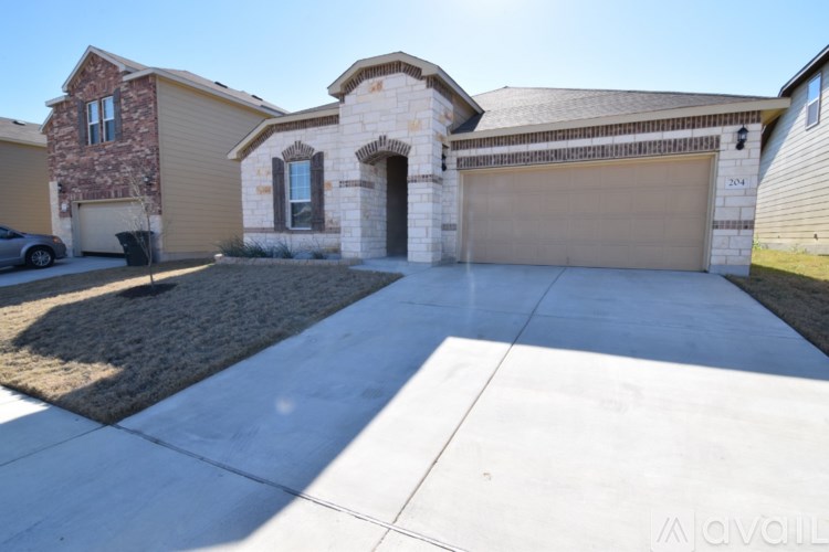 A house with a garage and driveway in front.