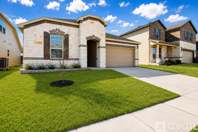 A house with a brown front yard and a driveway.