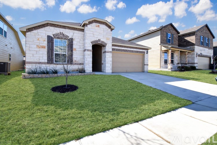 A house with a brown front yard and a driveway.