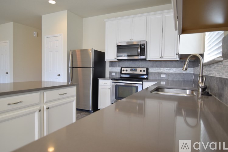 A kitchen with white cabinets and stainless steel appliances.