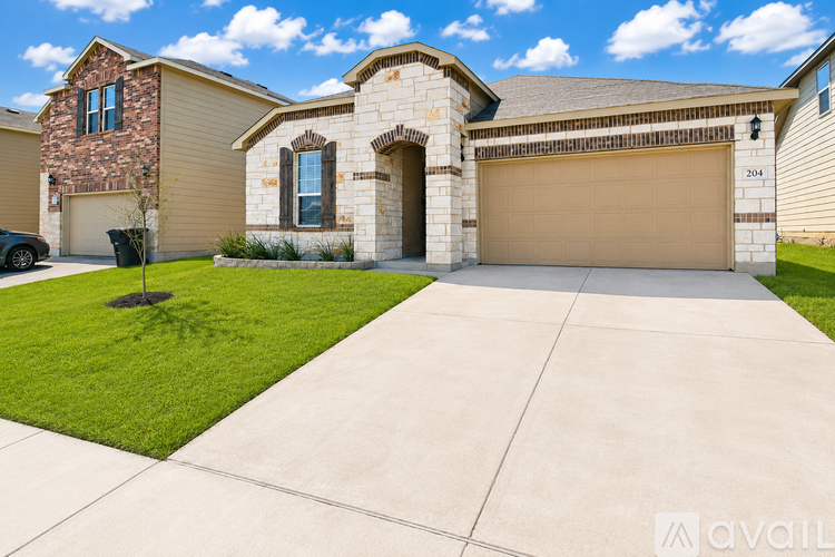 A house with a stone facade and a brown garage door.