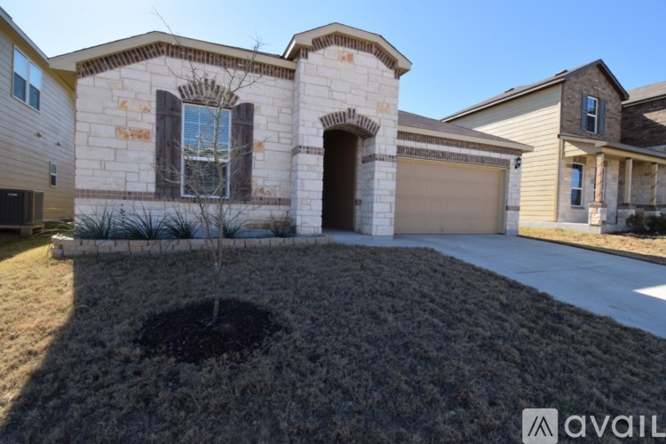A house with a stone facade and a brown garage door.