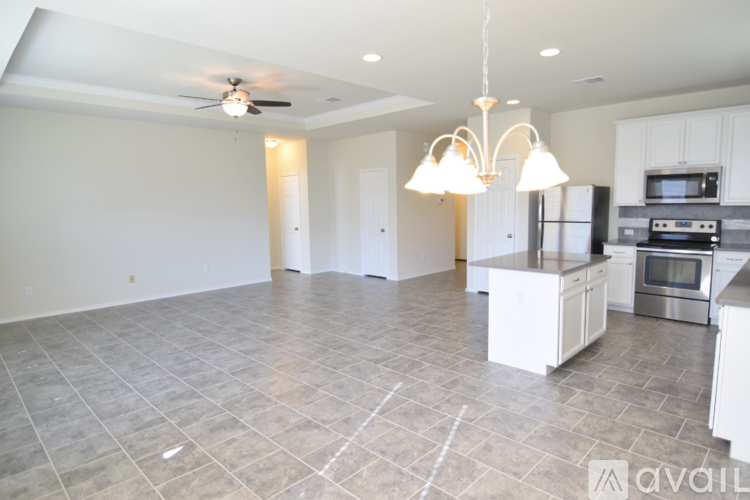 A kitchen with a refrigerator, microwave, and oven is available for rent.
