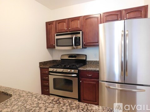 A kitchen with a stove, oven, microwave, and refrigerator.