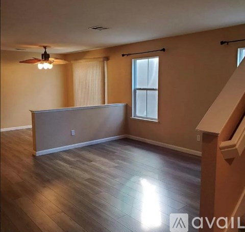 A kitchen with wooden floors and a white counter.