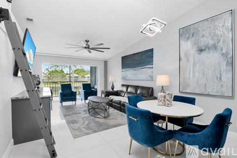A living room with a white ceiling and a large painting on the wall.