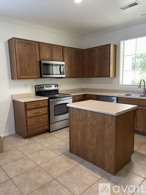 A kitchen with wooden cabinets and a white countertop.
