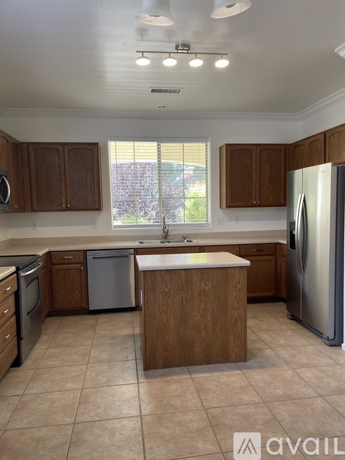 A kitchen with wooden cabinets and a white refrigerator.