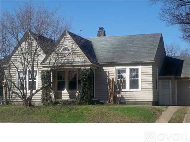 A house with a grey siding and a black roof.