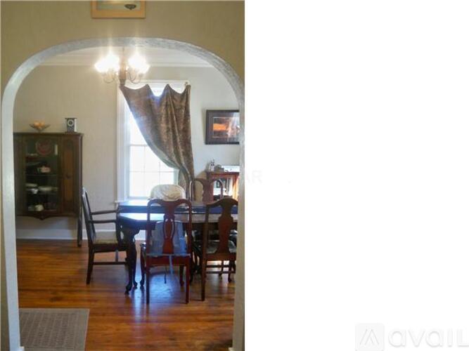 A dining room with a table set for four.