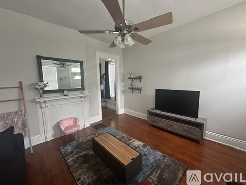 A living room with a television and a fireplace.