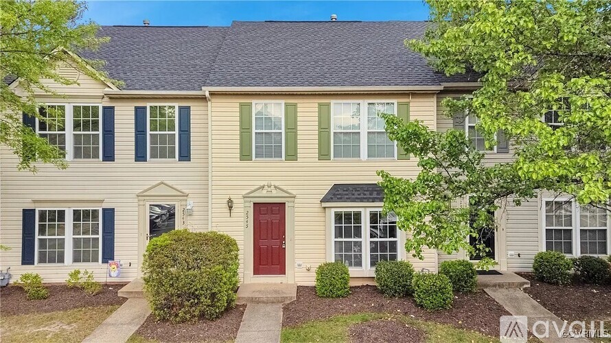 A house with a red door and green shutters.