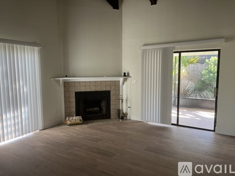 A living room with a fireplace and sliding glass doors.