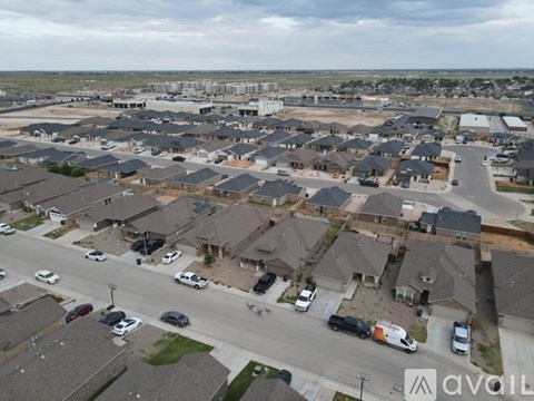 A bird's eye view of a residential area with houses and cars.