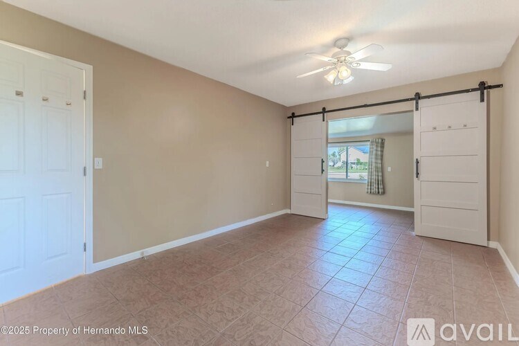 A room with a sliding door leading to a balcony.