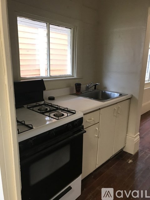 A kitchen with a white stove and black oven.