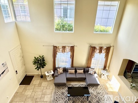 A living room with a grey couch and a black coffee table.