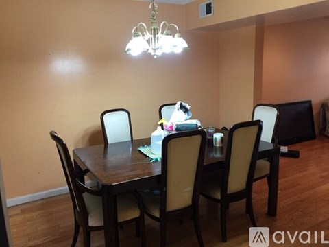 A dining room with a table set for four.