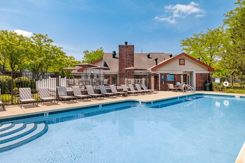 A pool with a building behind it.