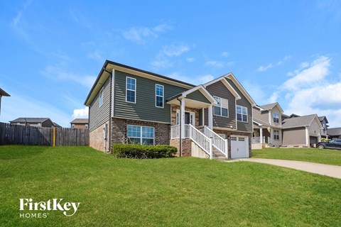 A house with a grey and white exterior is shown with the words "FirstKey Homes" on the bottom left.