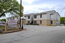 A sign for Parkside Apartments stands in front of a building.