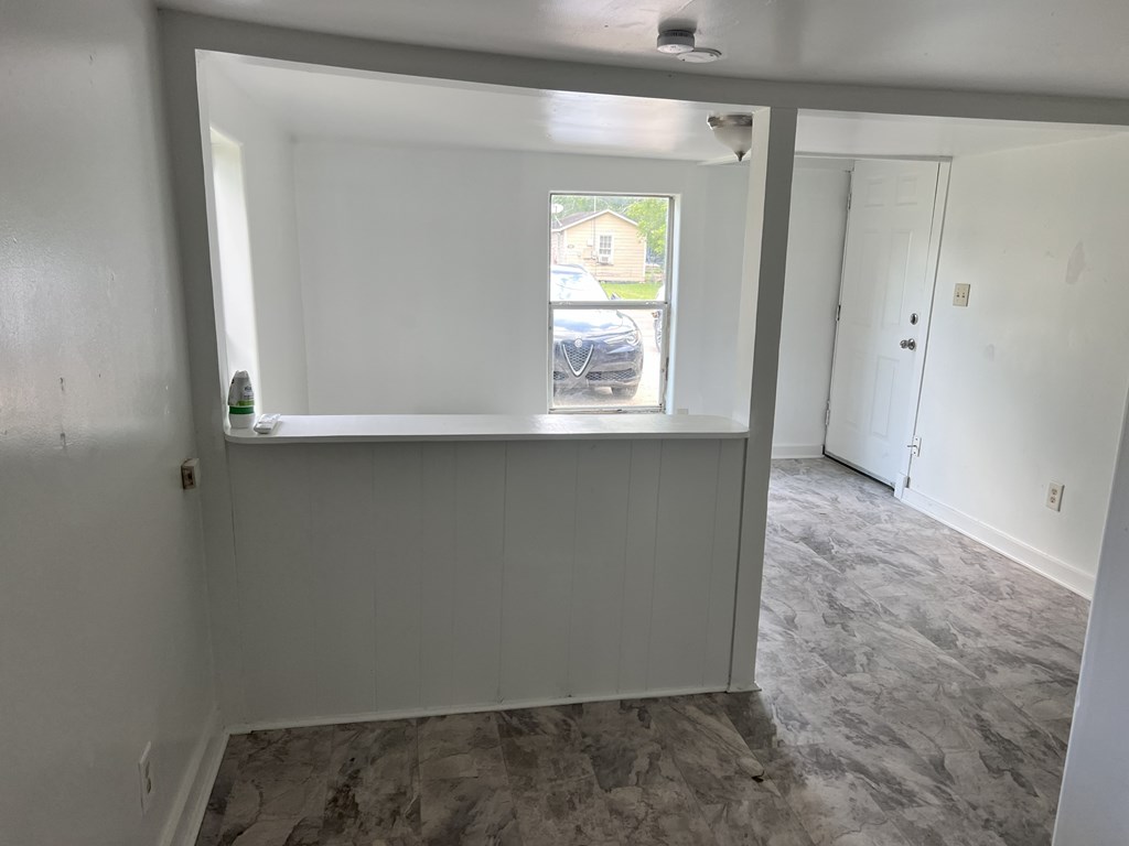 A room with a window and a door.