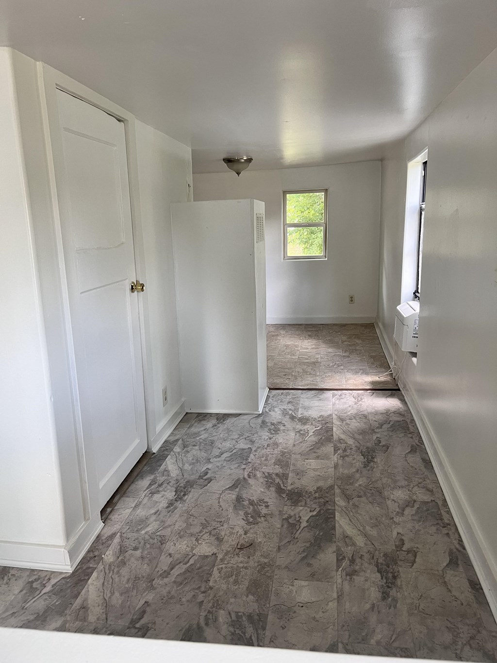 A room with a marble floor and white walls.