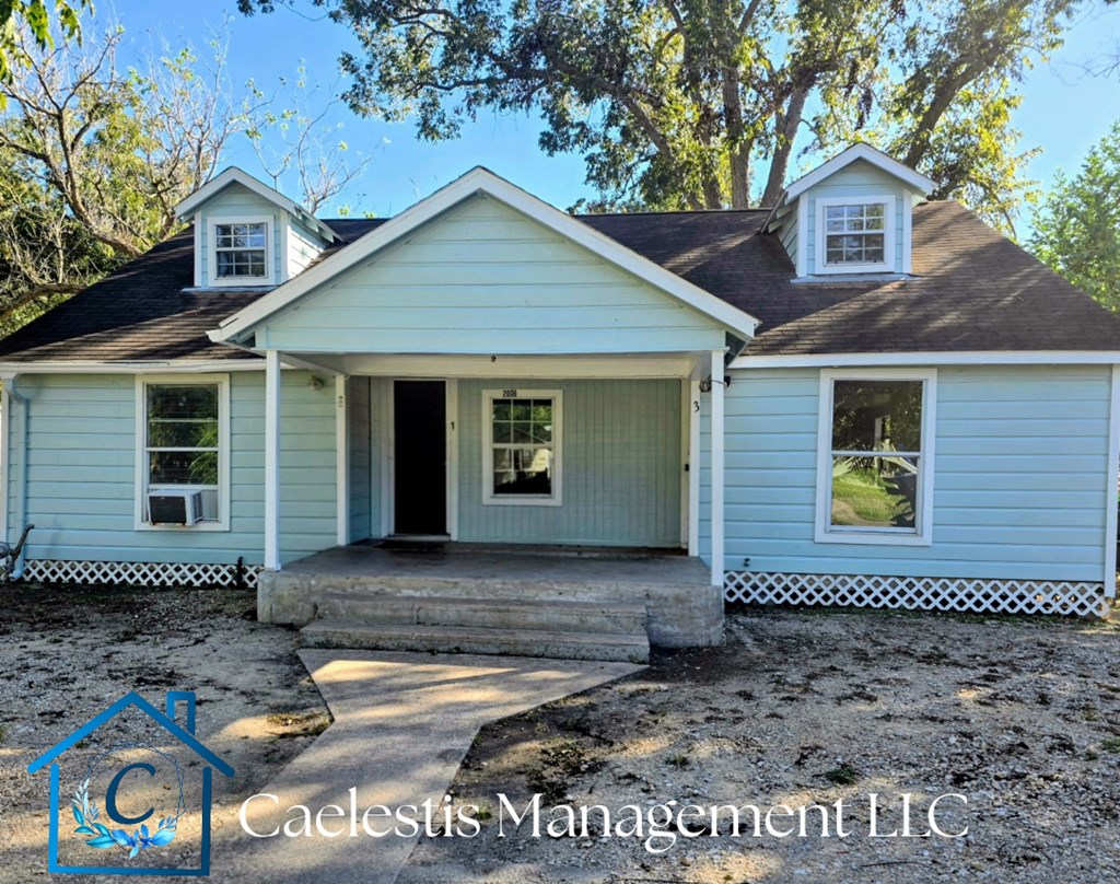 A blue house with a porch and a logo for Calecestis Management LLC.