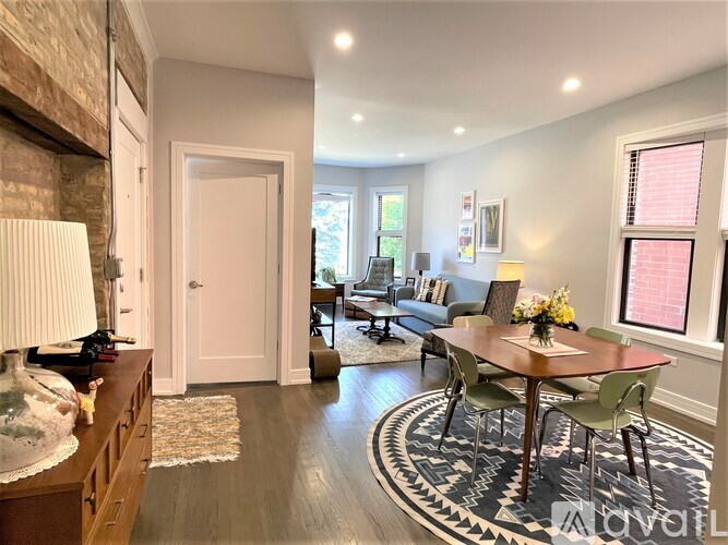 A dining room with a round table and chairs.
