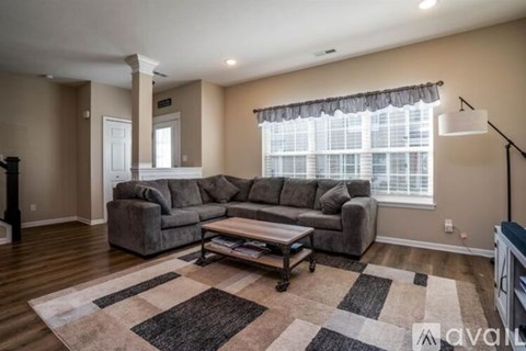 A living room with a grey sofa and a coffee table.