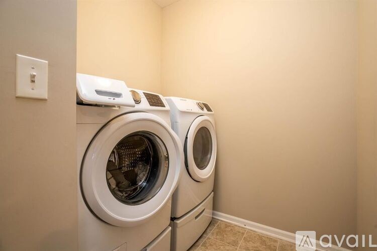 Two front loading washing machines in a laundry room.