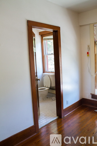 A room with a mirrored doorway leading to a bathroom.