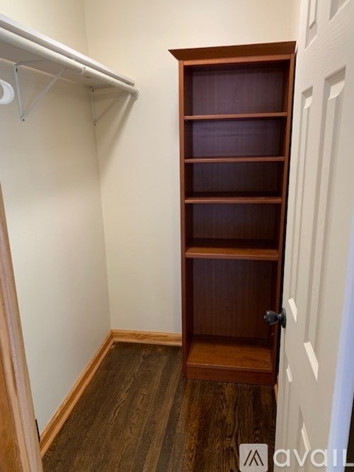 A wooden closet with a white door is shown.