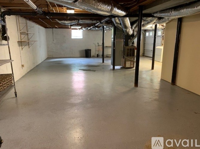 A spacious garage with a concrete floor and exposed ductwork.