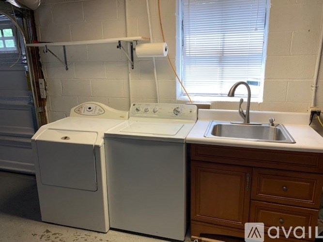 A white washing machine and dryer are in a laundry room.