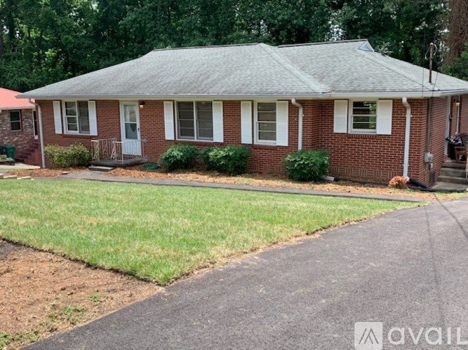 A house with a red brick exterior and a grey roof.