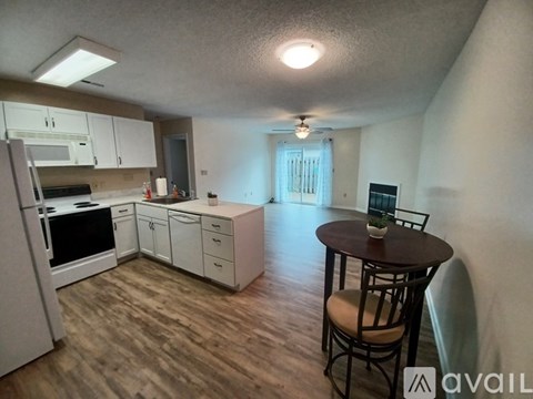A kitchen with a table and chairs in the middle of the room.