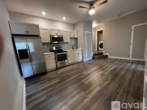 A kitchen with wooden floors and stainless steel appliances.