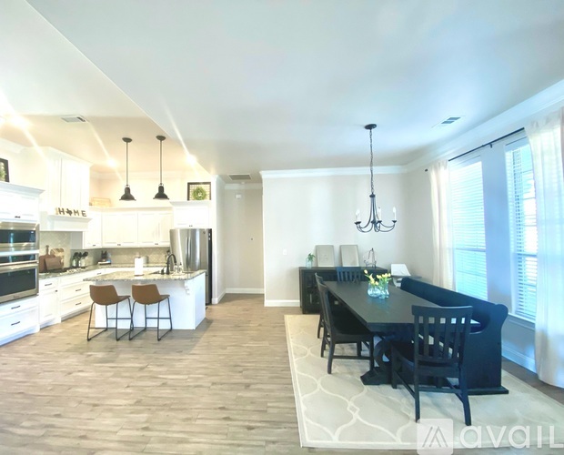 A modern kitchen with a dining table and chairs.