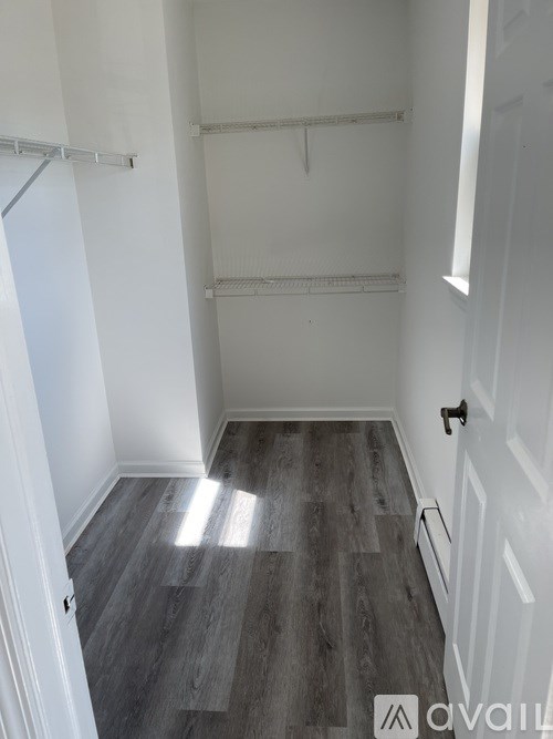 A room with white walls and a grey floor.