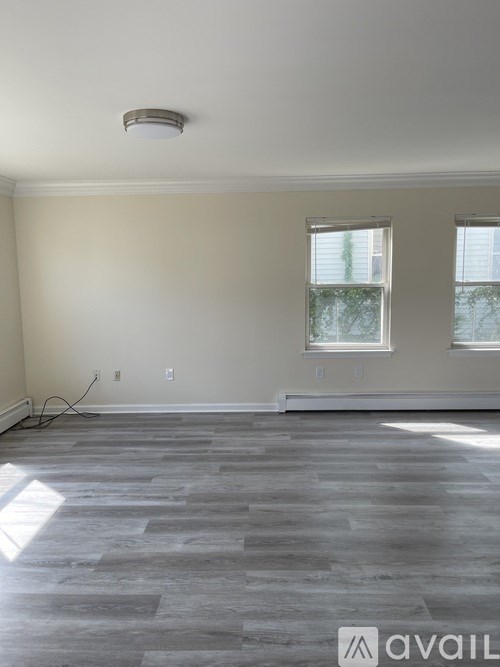A room with a grey floor and a window.