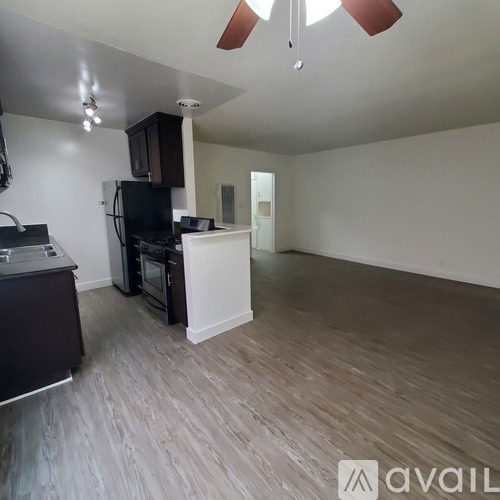A kitchen with a black fridge and a black oven.