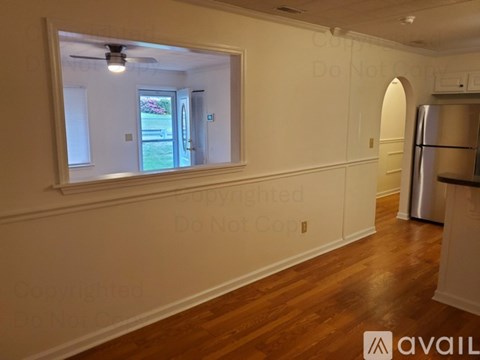 A kitchen with a refrigerator and a window.