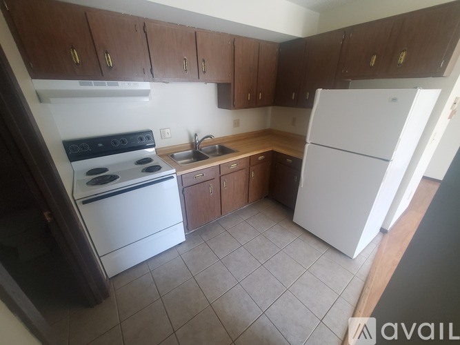 A kitchen with wooden cabinets and a sink.