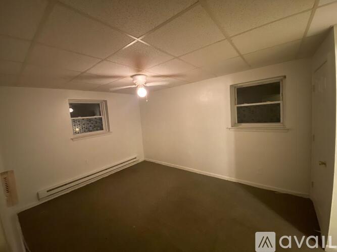 A room with a window and a ceiling fan.