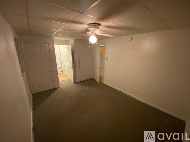 A room with a light on and a door at the end.