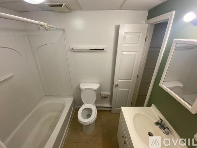 A bathroom with a toilet, sink, and bathtub.