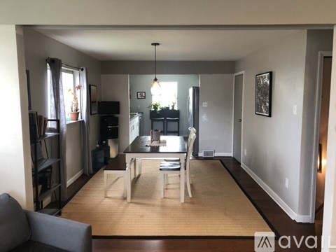 A living room with a grey couch and a wooden coffee table.
