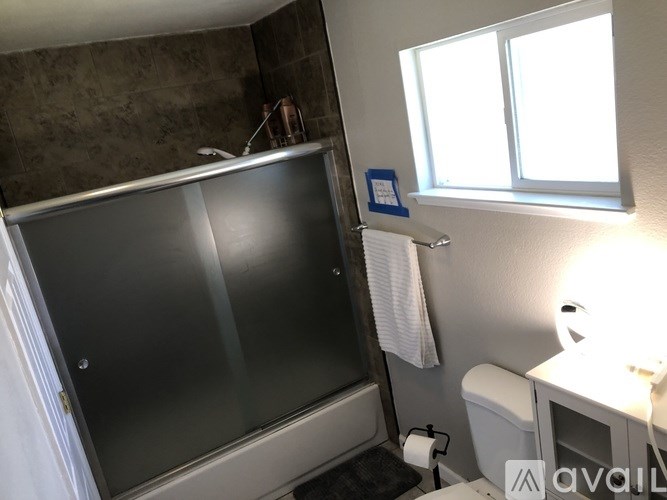 A bathroom with a toilet, sink, and shower.
