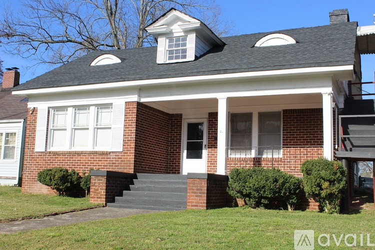 A house with a white front door and a brick facade.